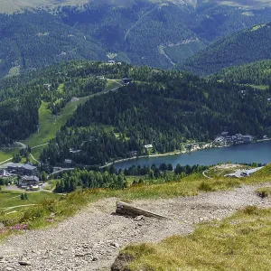 View of mountainous landscape with lake and forests in the foreground