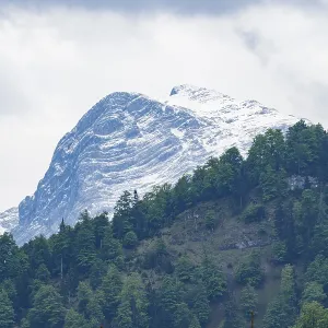 View into the mountains next to Lake Almsee on a rainy day in spring