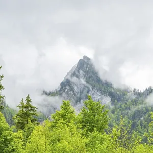 View into the mountains next to Lake Offensee on a rainy day in spring