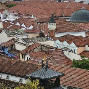 View of an old town with red tiled roofs and a dome