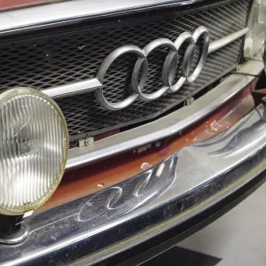 Front view of a red Audi classic car with radiator grille and chrome headlights