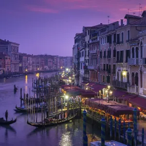 View from the Rialto Bridge on the Canal Grande with gondolier at sunset