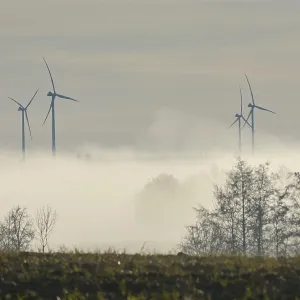 View from Rosengarten-Raibach of fog-shrouded wind turbines in the KohlenstraBe wind farm