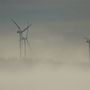 View from Rosengarten-Raibach of fog-shrouded wind turbines in the KohlenstraBe wind farm