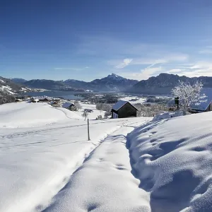 View of snow-covered Mondseeland with Schafberg and Drachenwand