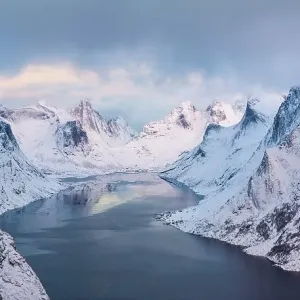View of snow-covered mountains and fjord View of snow-covered mountains and fjord