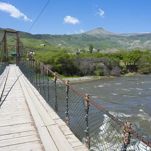 View of a swinging suspension bridge spanning a river