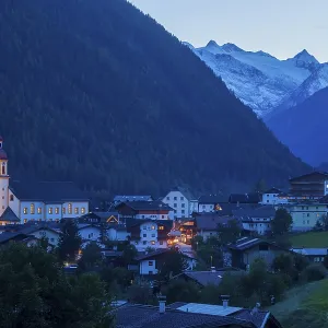 View of town with mountains and Stubai glacier at dusk View of town with mountains and Stubai glacier at dusk