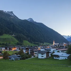 View of town with mountains and Stubai glacier at dusk