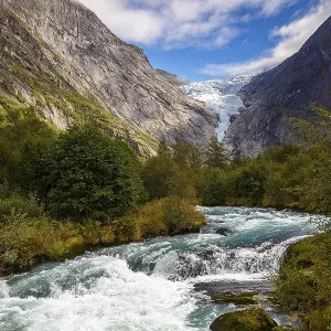 View across a travelling river to the Briksdalsbreen glacier in Norway
