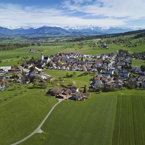 View of the village with Rigi and the snowy Alps in the back