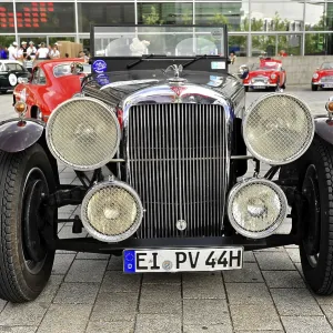 Front view of a vintage car with large headlights and stylish bumper Front view of a vintage car with large headlights and stylish bumper
