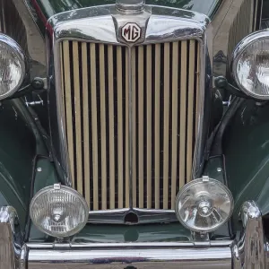 Front view of a vintage MG with distinctive radiator grille and double chrome-plated headlights