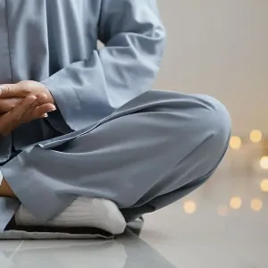 Front view woman meditating candles Front view woman meditating candles