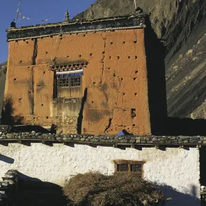 The village shrine or gompa with cliffs behind in the village of Kagbeni in southern Mustang in west Nepal The village shrine or gompa with cliffs behind in the village of Kagbeni in southern Mustang in west Nepal