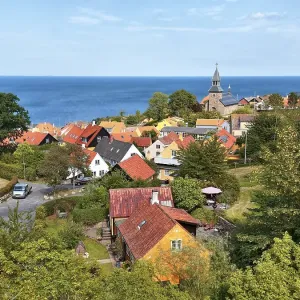Village view Gudhjem, view over the roofs and the church to the Baltic Sea with Christianso