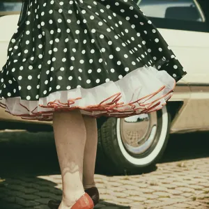 Vintage American road cruiser Buick with woman and petticoat