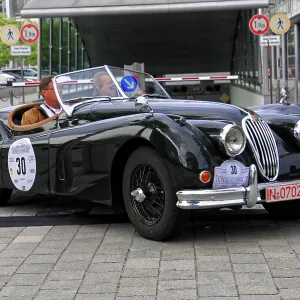 Vintage black roadster car with open top on paving stone