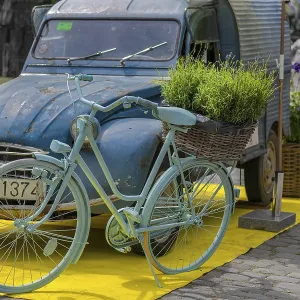 Vintage car, bicycle, flowers, decoration in front of castle Vintage car, bicycle, flowers, decoration in front of castle