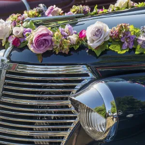 Vintage car with floral decoration and chrome-plated radiator grille Vintage car with floral decoration and chrome-plated radiator grille