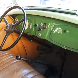 Vintage car interior with classic steering wheel Vintage car interior with classic steering wheel