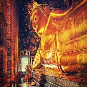 Vintage retro effect filtered hipster style image of reclining Buddha gold statue Vintage retro effect filtered hipster style image of reclining Buddha gold statue