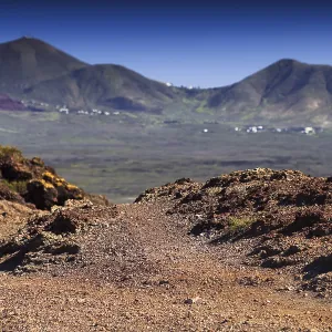 Volcanic landscape with mountains and eroded soil under blue sky Volcanic landscape with mountains and eroded soil under blue sky