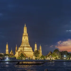 Wat Arun, Temple of Dawn at sunset with dark clouds Wat Arun, Temple of Dawn at sunset with dark clouds