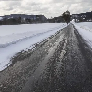 Wet and slippery, a small road in Norway Wet and slippery, a small road in Norway