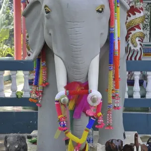 White elephant statue decorated in artificial flower garlands White elephant statue decorated in artificial flower garlands