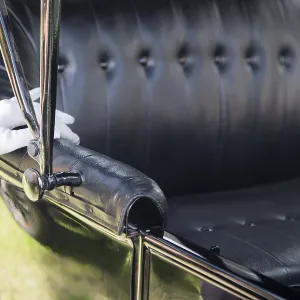White gloved female hand on leather of antique model T automobile seat White gloved female hand on leather of antique model T automobile seat