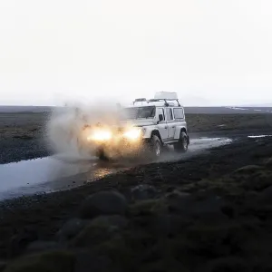 White Land Rover in action with splashing water White Land Rover in action with splashing water