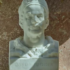 White marble bust of Jakob Fugger in front of a reddish wall