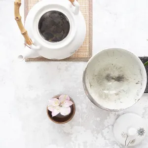 White teapot with bamboo handle White teapot with bamboo handle