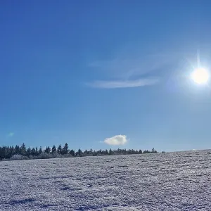 Wide expanse of snow under a clear blue sky with bright sun Wide expanse of snow under a clear blue sky with bright sun