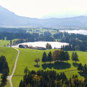 Wide, green landscape with wooded areas
