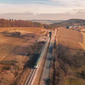 Wide landscape with railroad tracks and a distant train Wide landscape with railroad tracks and a distant train