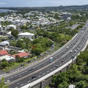 Wide, modern viaduct of the national road RN1 and part of the Route des Tamarins with lively traffic (cars and lorries) Wide, modern viaduct of the national road RN1 and part of the Route des Tamarins with lively traffic (cars and lorries)