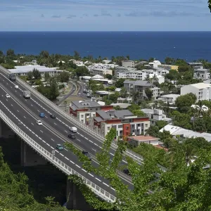 Wide, modern viaduct of the national road RN1 and part of the Route des Tamarins with lively traffic (cars and lorries) Wide, modern viaduct of the national road RN1 and part of the Route des Tamarins with lively traffic (cars and lorries)