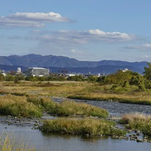 Wide river landscape with mountains in the background and clear blue sky Wide river landscape with mountains in the background and clear blue sky