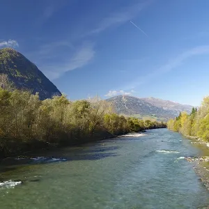 Wide river snakes through an autumnal valley