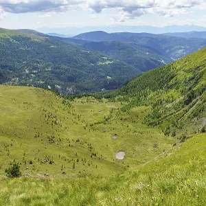Wide valley with green hills and forests