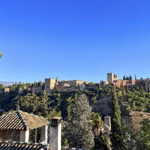 Wide view of the Alhambra over rooftops of the old town
