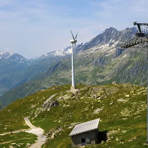 Wind Turbine and Mountain with Glacier and Overhead Cable Car and Blue Sky Wind Turbine and Mountain with Glacier and Overhead Cable Car and Blue Sky