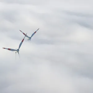 Wind turbines sticking out of the fog Wind turbines sticking out of the fog