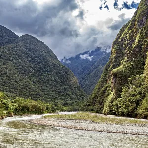 Winding river path through a lush green valley