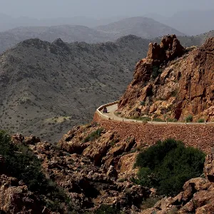 Winding road along the rocks in the mountains around Anergui