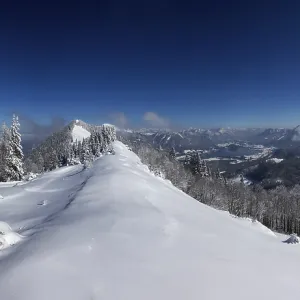 Winter landscape covered in deep snow in the Osterhorn group with a view from Pillstein to Zwoelferhorn