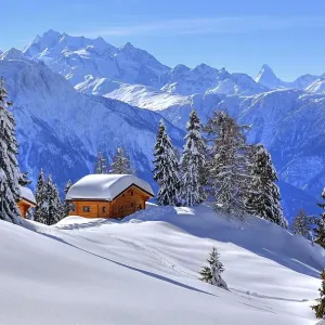 Winter landscape with deep snow-covered chalets Winter landscape with deep snow-covered chalets