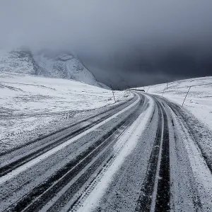 Winter storm, dark clouds above the pass road Rekvikvegen Winter storm, dark clouds above the pass road Rekvikvegen